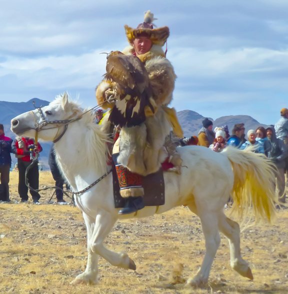 A Kazakh hunter poses with his golden eagle ready to hunt