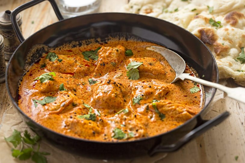 Orange colored, butter chicken curry with tender chicken breast, cream, butter and honey