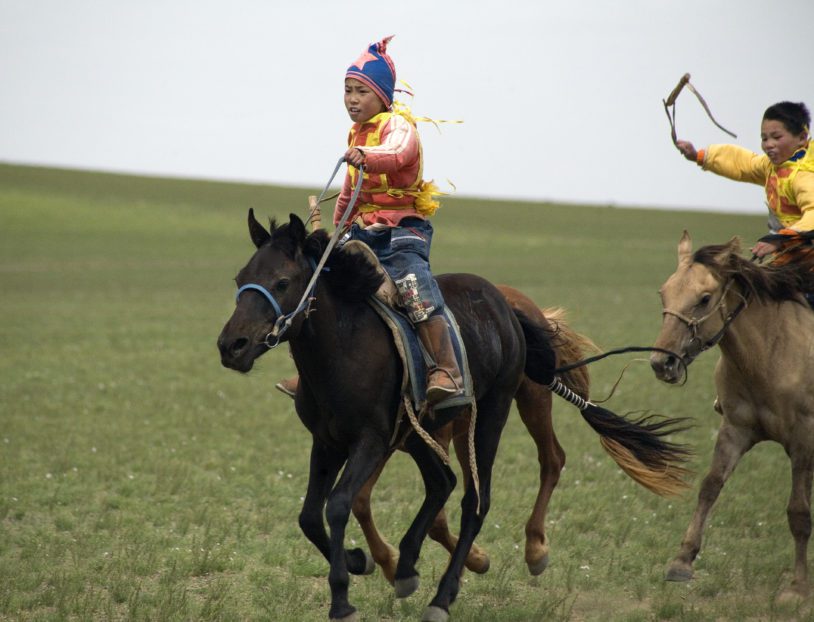 Boys on horses at Naadam Festival