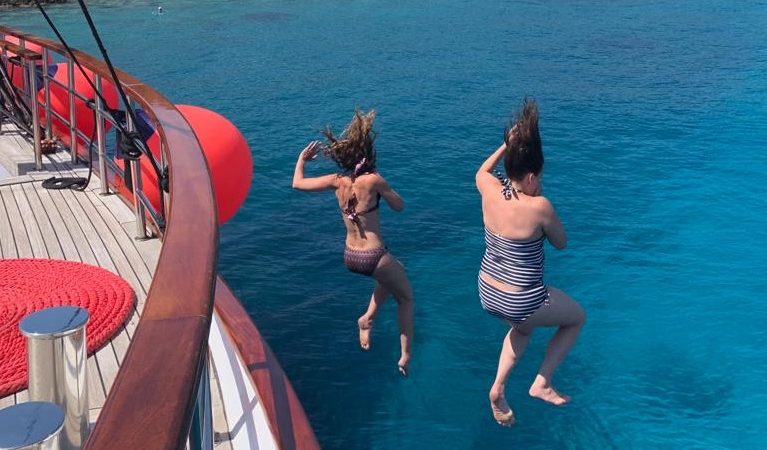 Adventure Women jumping into the Adriatic Sea