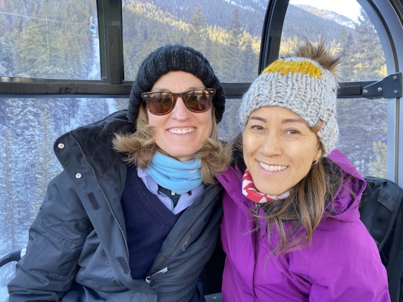 Two smiling women with winter gear on