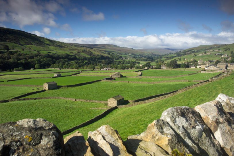 Green pastures, cottages and rock walls in Swaledale