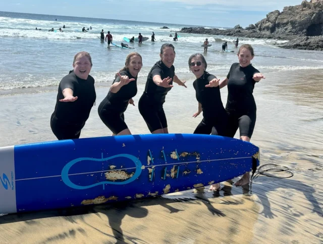 A group of travelers ready to go surfing.