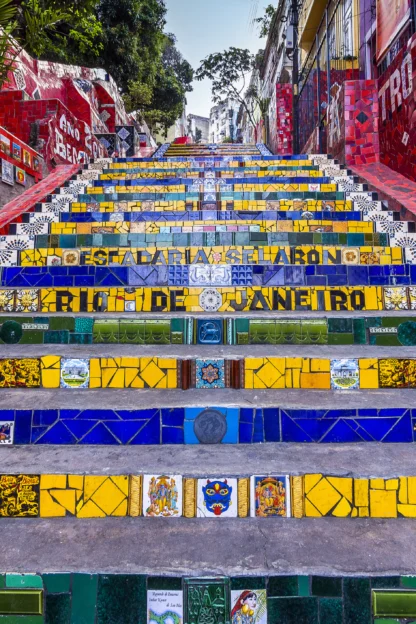 Colorful tiled steps of Escadaria Selarón in Rio de Janeiro, featuring vibrant red, yellow, and blue designs with artistic patterns.