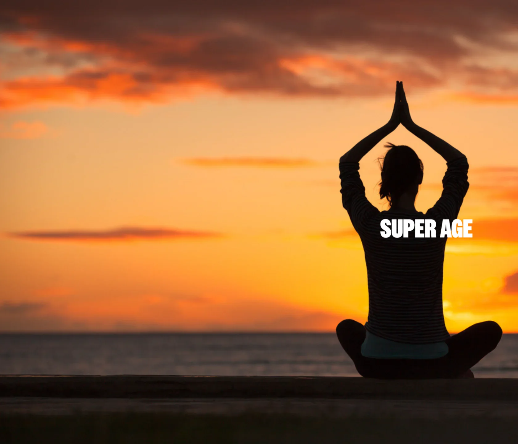 A person sits cross-legged facing the ocean at sunset, hands together above their head. The words "SUPER AGE" are overlaid on their torso.